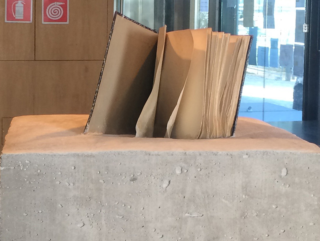 concrete sculpture with book, book sculpture